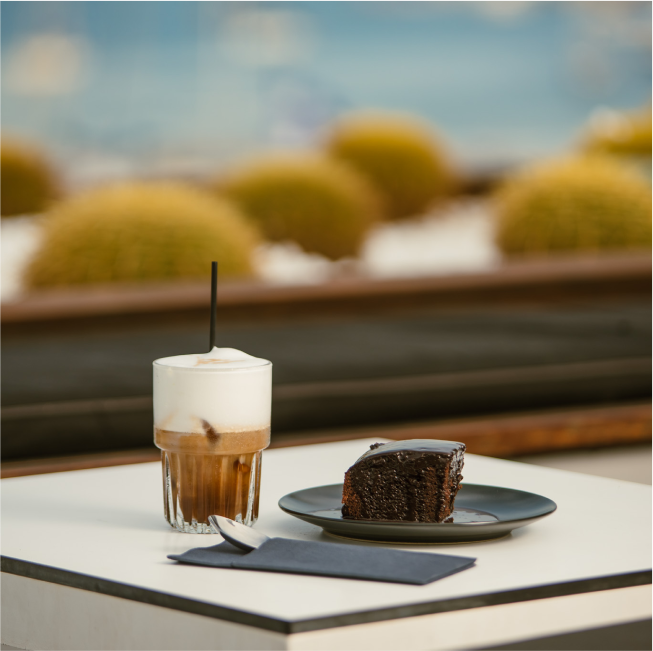 Morning menu delight: a refreshing iced latte paired with a slice of chocolate cake