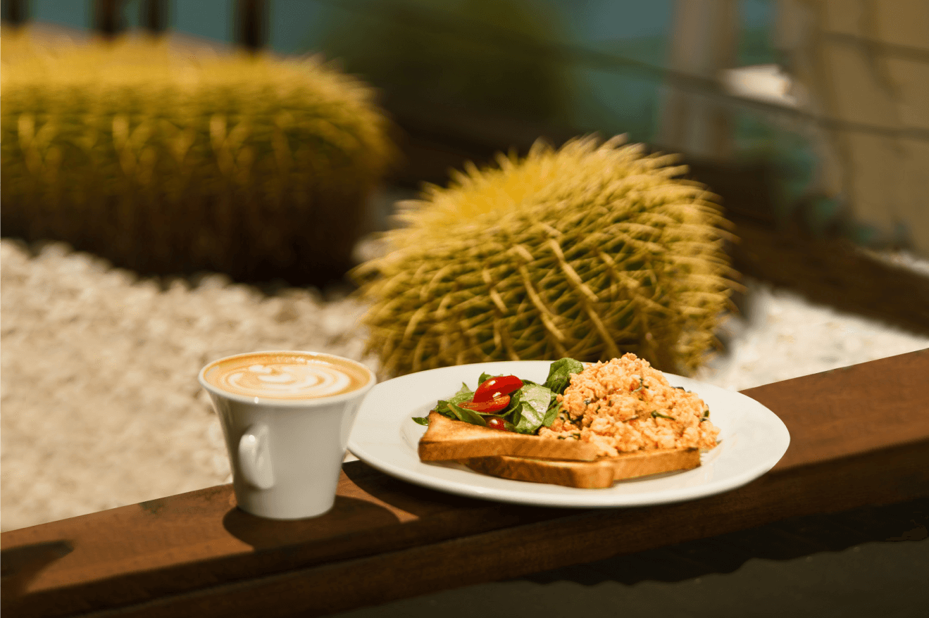Morning menu delight: a perfectly crafted cappuccino with a specialty microroastery blend and delicious scrambled eggs on toast