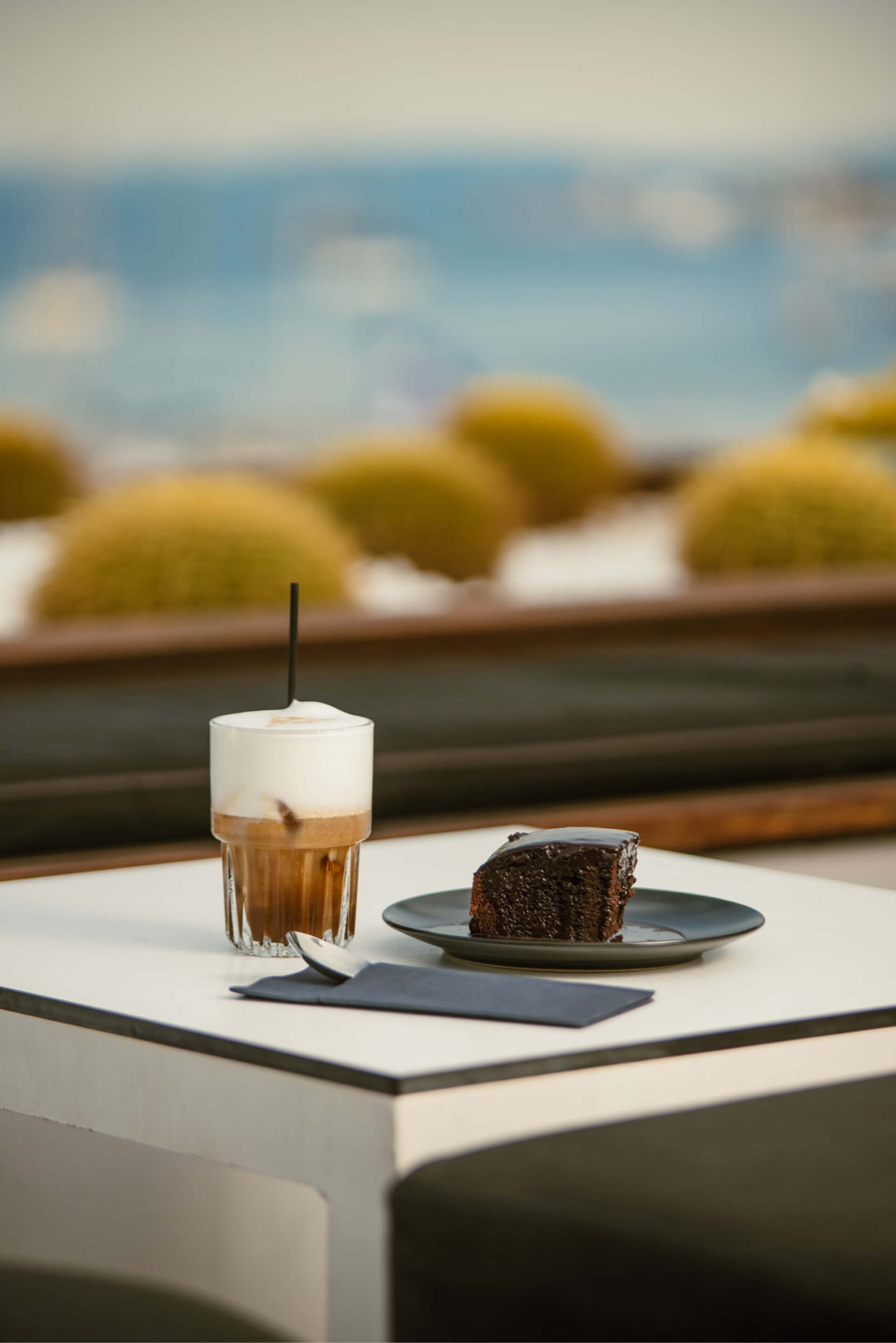 Table set with iced latte and chocolate cake, a tempting treat for indulgence