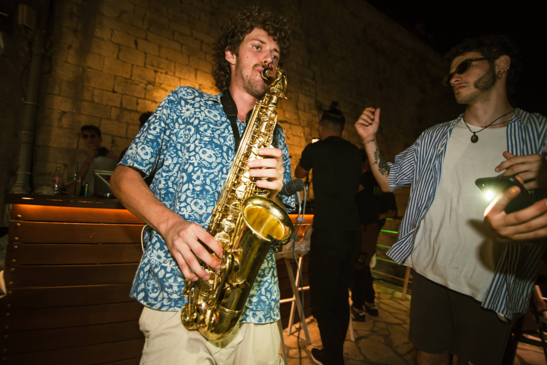 Saxophone player performing at one of Azur's musical events, creating a captivating atmosphere